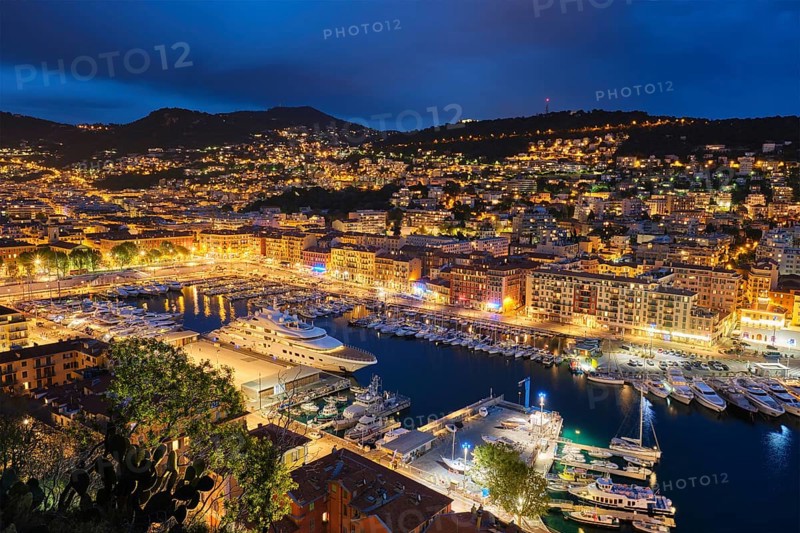 View of Old Port of Nice with luxury yacht boats from Castle Hill, France, Villefranche-sur-Mer, Nice, Cote d'Azur, French Riviera in the evening blue hour twilight illuminated, Europe