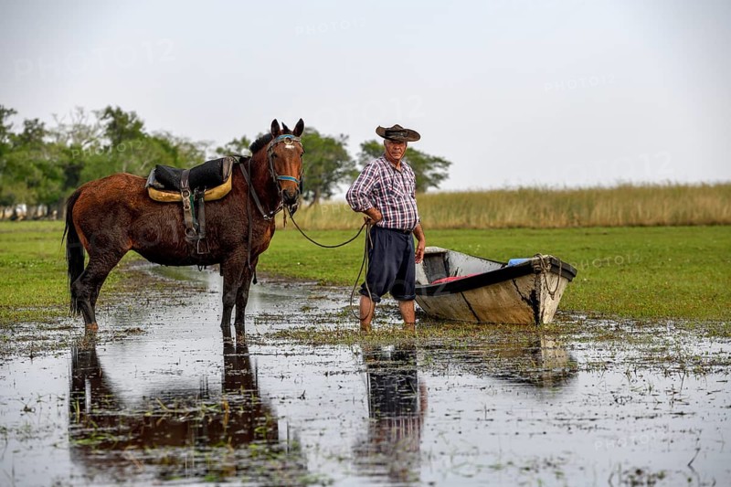 Gaucho with horse and boat at Puesto Mingo, Esteros del Iberá, near Concepción del Yaguareté Corá, Corrientes Province, Argentina, South America