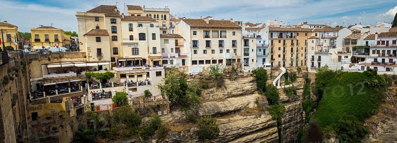 Ronda, Spain, April 2023: View on the restaurants and houses built on the cliffs on Puerte Nuevo in Ronda, Europe