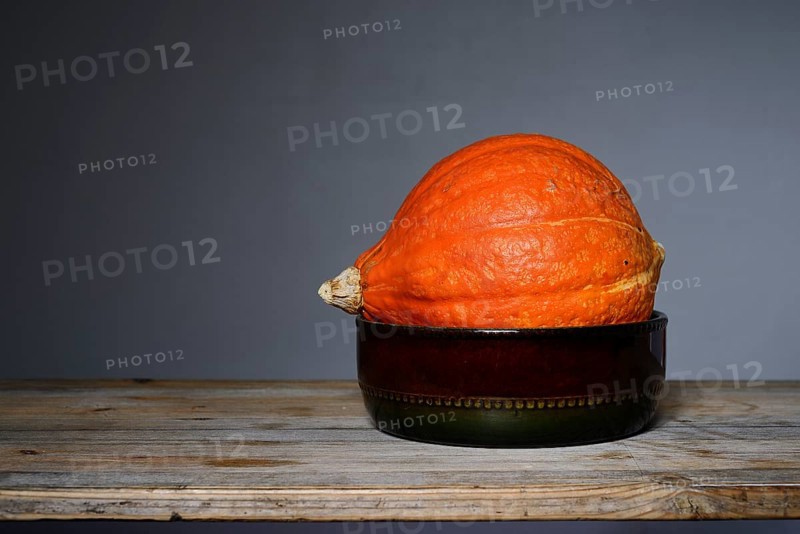 Bright orange Hokkaido pumpkin in a ceramic bowl