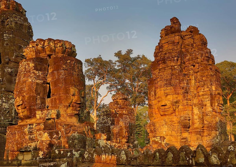 Giant stone faces at Bayon Temple at sunset, Angkor Wat, Cambodia, Asia