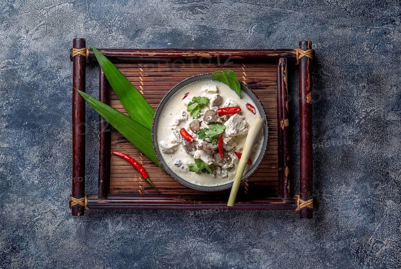 Thai chicken mushroom coconut milk soup TOM KHA GAI in bowl with thai spices