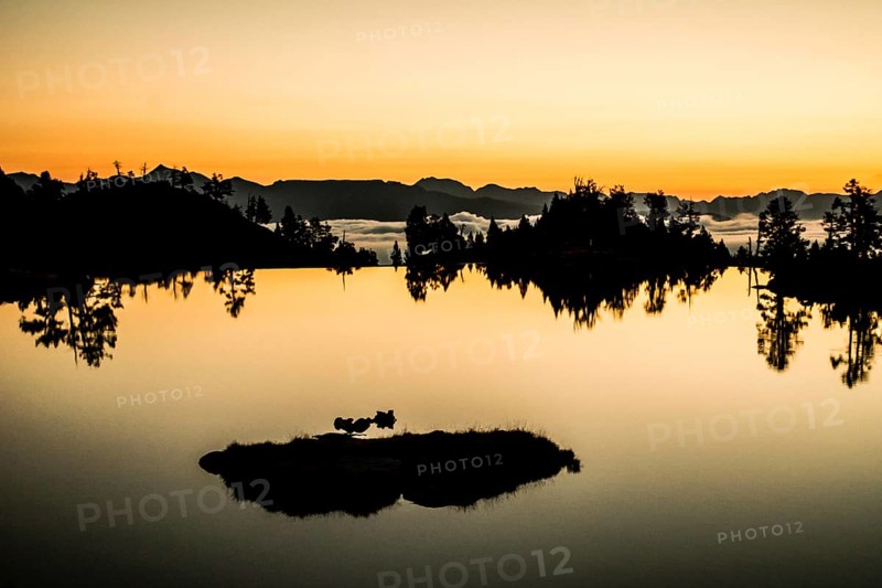 Sunrise lake in the Spanish Pyrenees, located at mountain hut JM Blanc, Aigüestortes i Estany de Sant Maurici national park