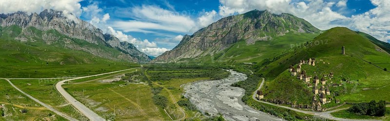 Aerial panorama of Dead Town Dargavs In North Ossetia. The ancient cemetery of the Alans. Many small stone mausoleums, standing on the side of a mountain