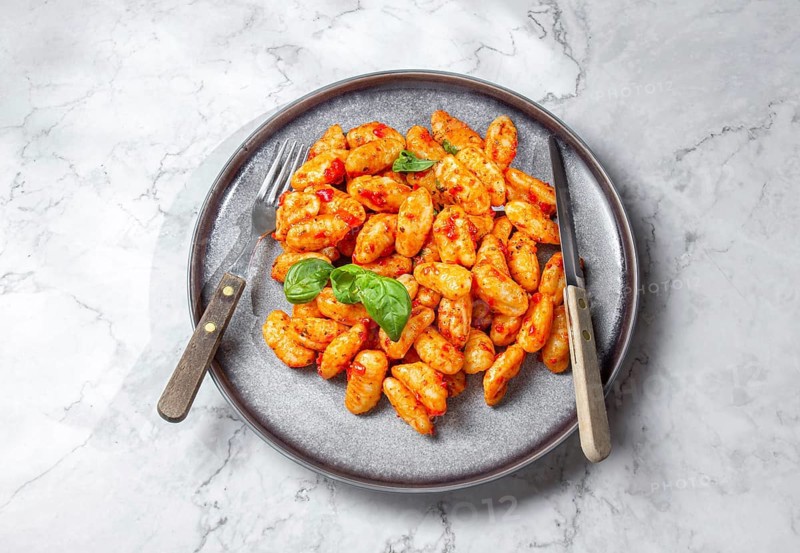 Food, Traditional Italian potato Gnocchi with tomato sauce and fresh basil on gray plate, marbled backround
