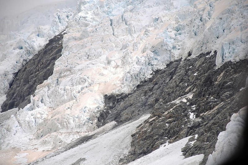Franz Josef Glacier, Westland, New Zealand. Brown discolouration on the snow is smoke from bushfires in Australia