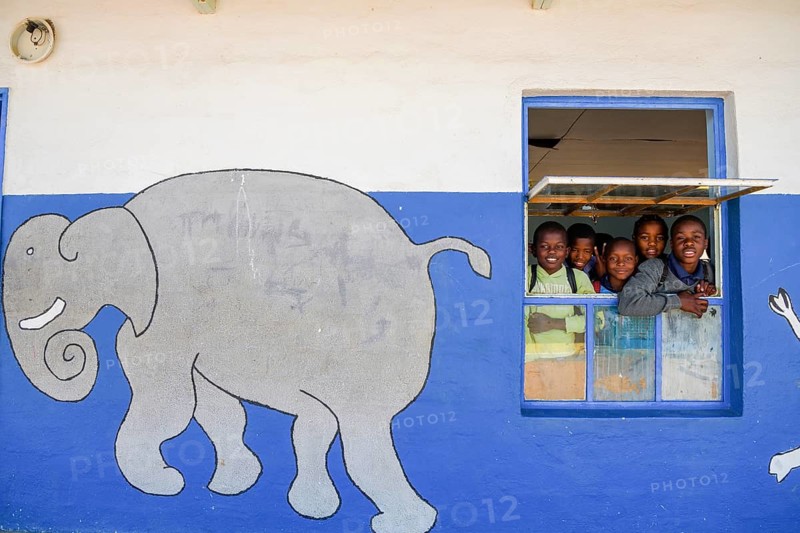 Children look out of the window of their classroom at Gariseb Primary School, boarding school for 350 children, Elephant, Anixab, Ugab Dry River, Damaraland, Kunene Region, Namibia, Africa