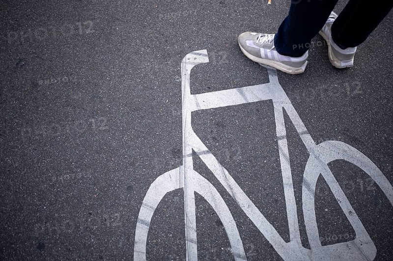 Close-up, shoes, sneakers, pedestrian standing on cycle path, marking, labelling, pictogram, traffic, Stuttgart, Baden-Württemberg, Germany, Europe