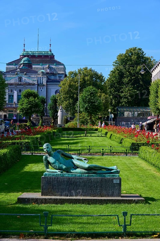 Lying poet statue in front of a historic building and sunny weather, Bergen, Vestland, Norway, Europe
