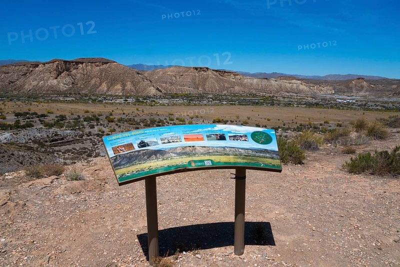 Viewpoint with an information board in a desert landscape with mountains and a clear sky, Llano de Buho, Tabernas Desert, Desierto de Tabernas, location of numerous films and westerns, Tabernas, Almeria, Andalusia, Spain, Europe