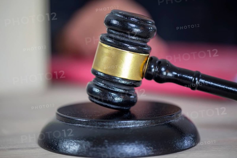 Symbolic image of a court hearing: close-up of a judge's gavel