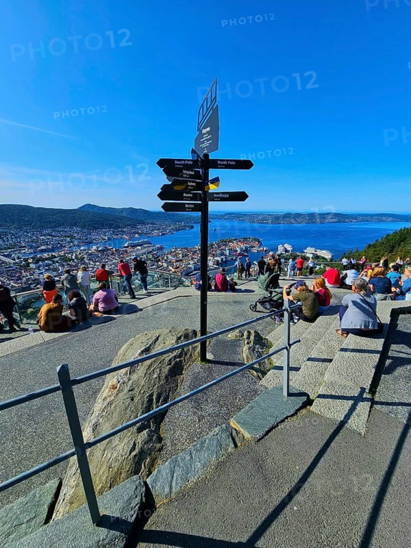 View of the city of Bergen with fjord, Bergen, signposts and a crowd of people admiring the landscape, Fløibanen mountain station, Bergen, Vestland, Norway, Europe