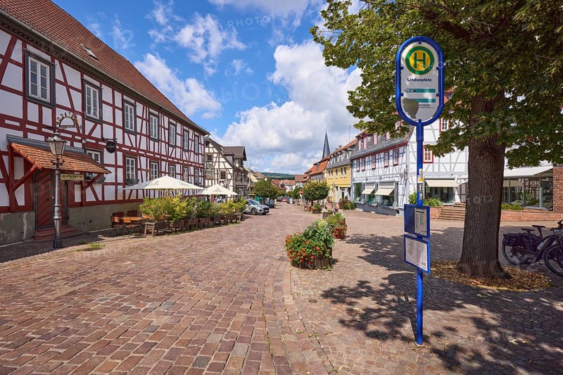 Lindenplatz with bus stop, restaurant and cobbled street in Michelstadt, Odenwald, Odenwaldkreis, Hesse, Germany, Europe