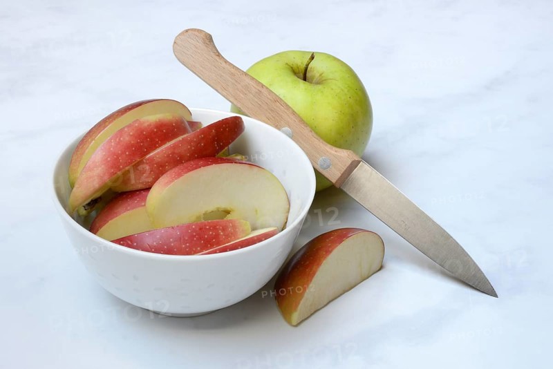 Apple and apple slices in peel, sliced apple with knife