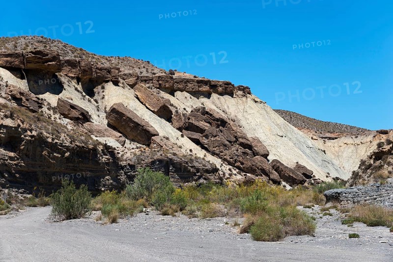 Rocks and cliffs rise in an arid desert landscape under a clear blue sky, La Tortuga, Tabernas Desert, Desierto de Tabernas, location of numerous films and westerns, Tabernas, Almeria, Andalusia, Spain, Europe