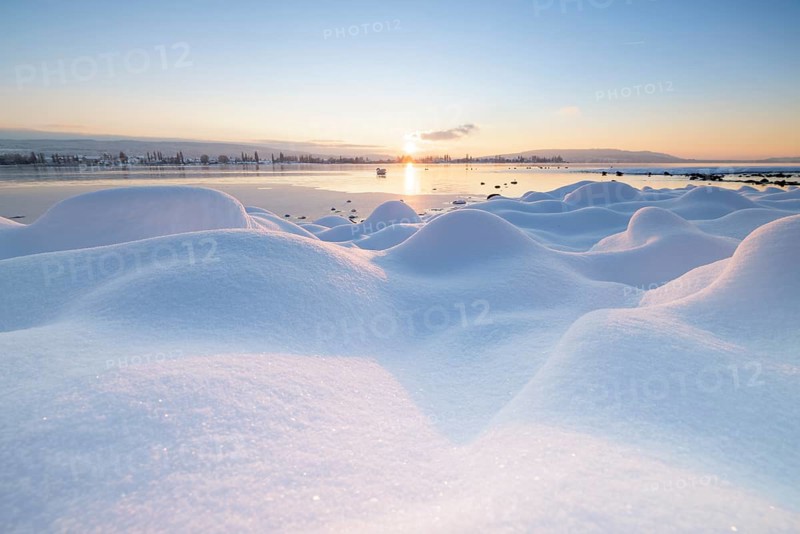 Winter lake at sunrise, many snow hills and icy atmosphere, Seegarten, Allensbach, Lake Constance, Baden-Württemberg, Germany, Europe