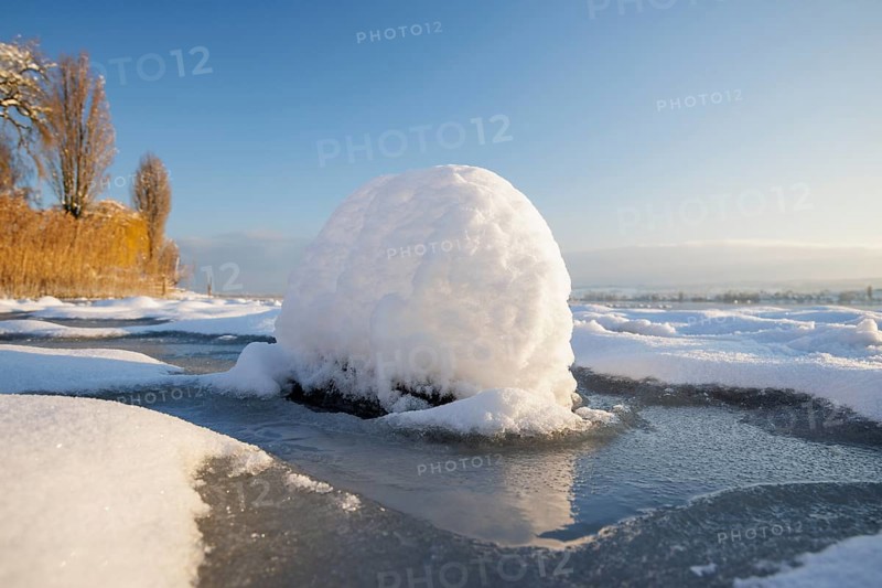 Snow globe on the ice of a frozen lake, Seegarten, Allensbach, Lake Constance, Baden-Württemberg, Germany, Europe