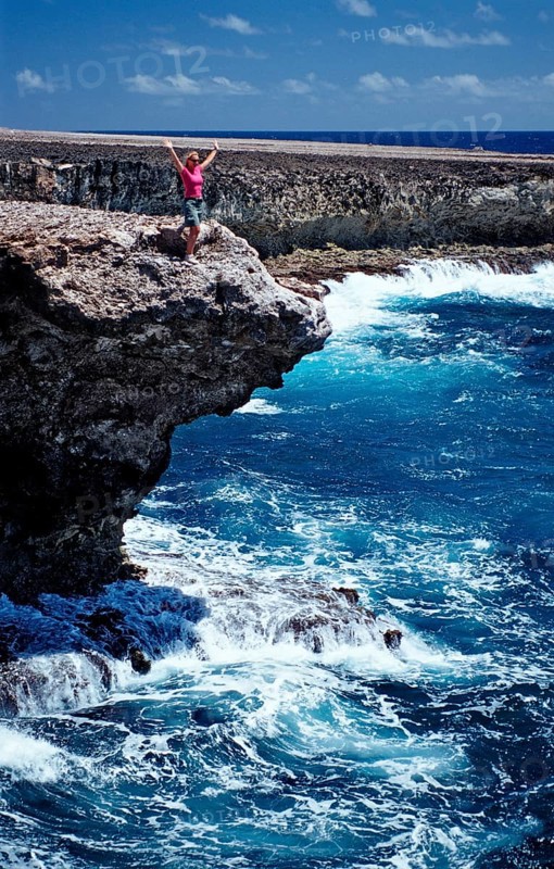 Woman watching surf on the coast, Netherlands Antilles, Bonaire, Caribbean, Caribbean Sea, Washington Slagbaai National Park, Supladó