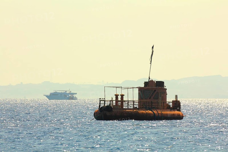 Abandoned rusty ship at anchor in Red sea