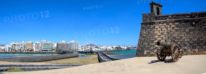 Arrecife, Lanzarote, March 2023: View on the cannon of Castillo de San Gabriel with Arrecife city in the background