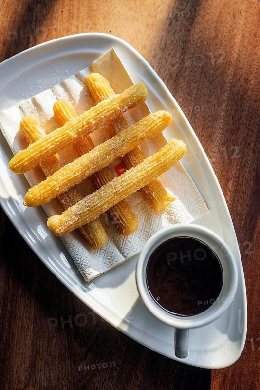 Churros and chocolate spanish donuts pastry doughnuts with sauce breakfast snack