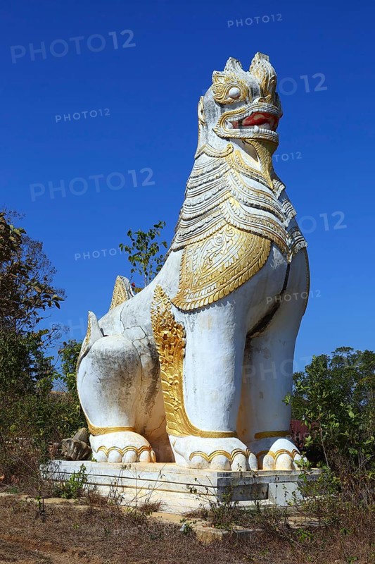 Ancient statue of lion guardian in Shwe Inn Thein Paya temple complex near Inle Lake in central Myanmar (Burma)