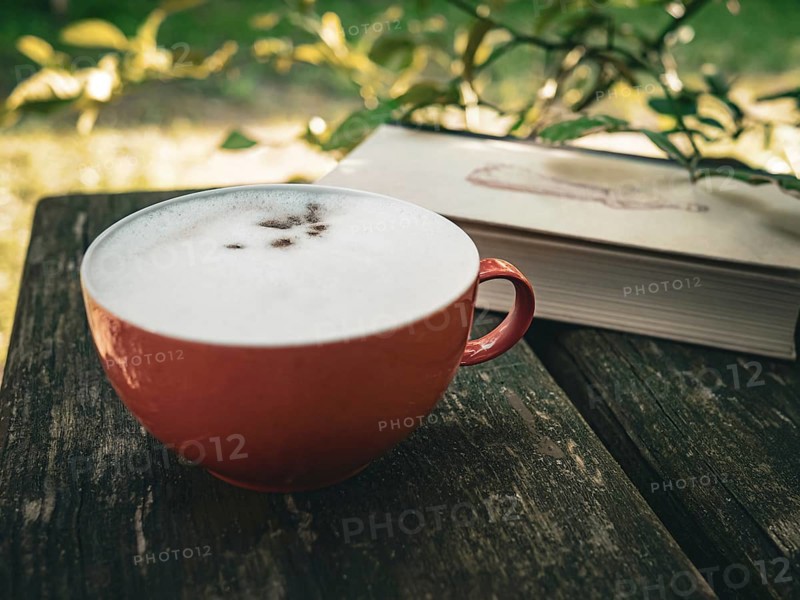 Drinking coffee and reading a book in the garden