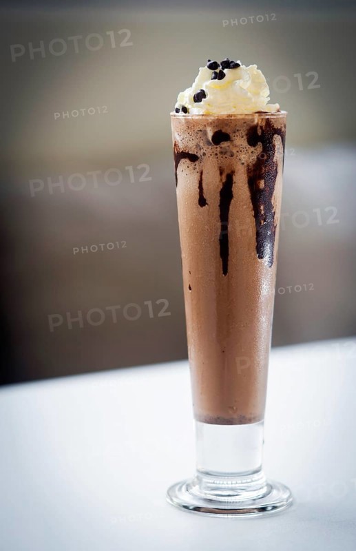 Gourmet chocolate and ice cream milkshake dessert in tall glass