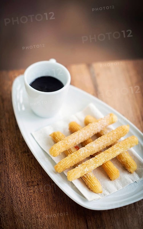 Churros and chocolate spanish donuts pastry doughnuts with sauce breakfast snack
