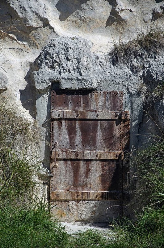 Old iron door set in a cliff face, Dunedin, South Island, New Zealand, Oceania