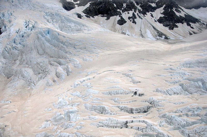 Franz Josef Glacier, Westland, New Zealand. Brown discolouration on the snow is smoke from bushfires in Australia