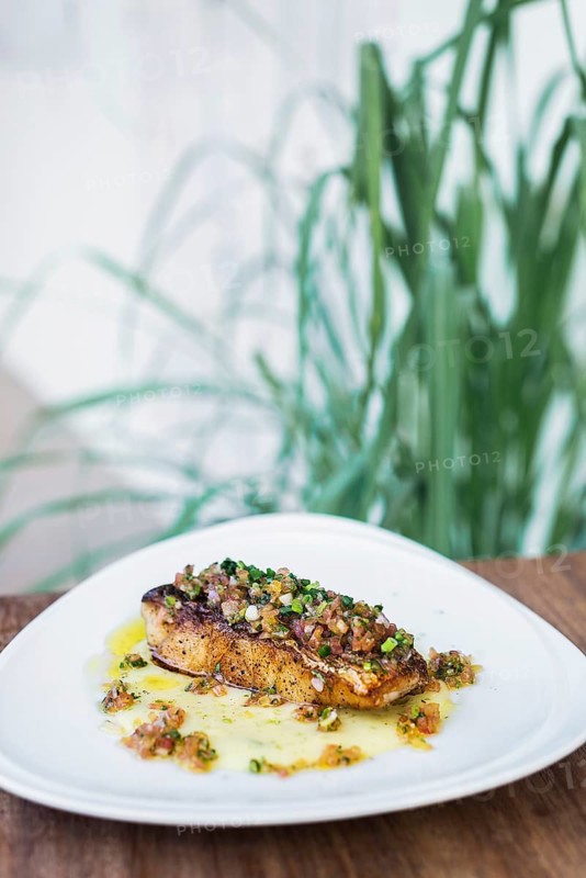 Fresh fish fillet with spicy salsa and olive oil sauce