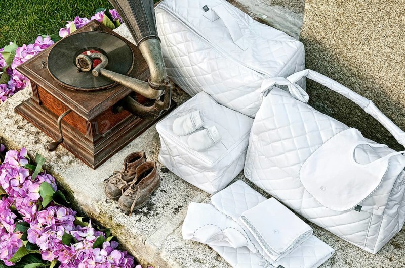 Vintage baby clothes and gramophone in garden
