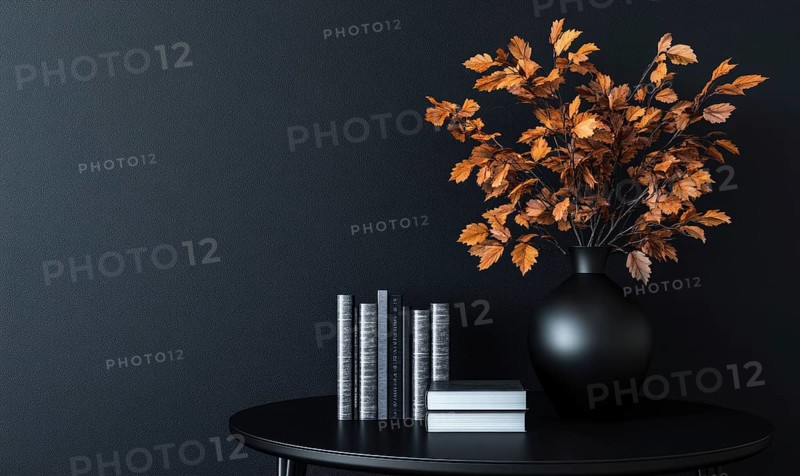 Sleek black table with a couple of books and a vase filled with autumn foliage AI generated