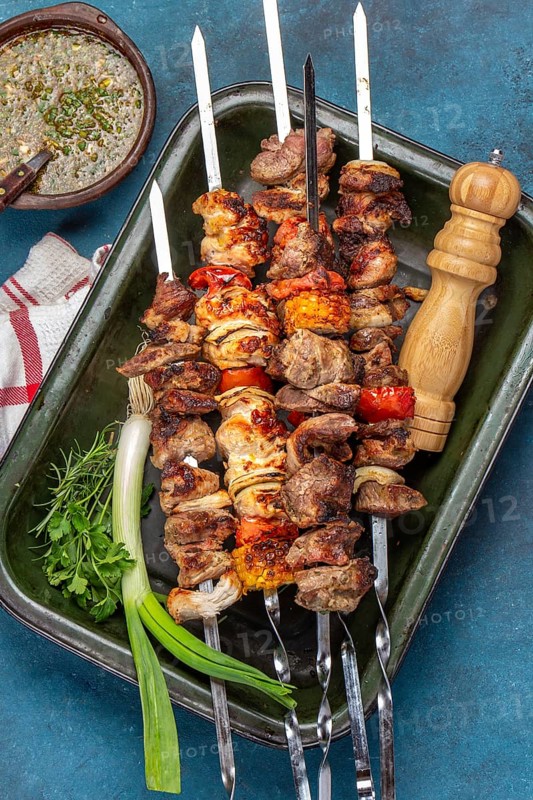 Food Photography, Bbq grilled meat pork, chicken and vegetable skewers on tray. Top view, flat lay. Blue background