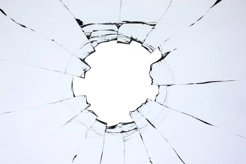 Hole in the glass, broken window with cracks texture. Effect of broken transparent glass