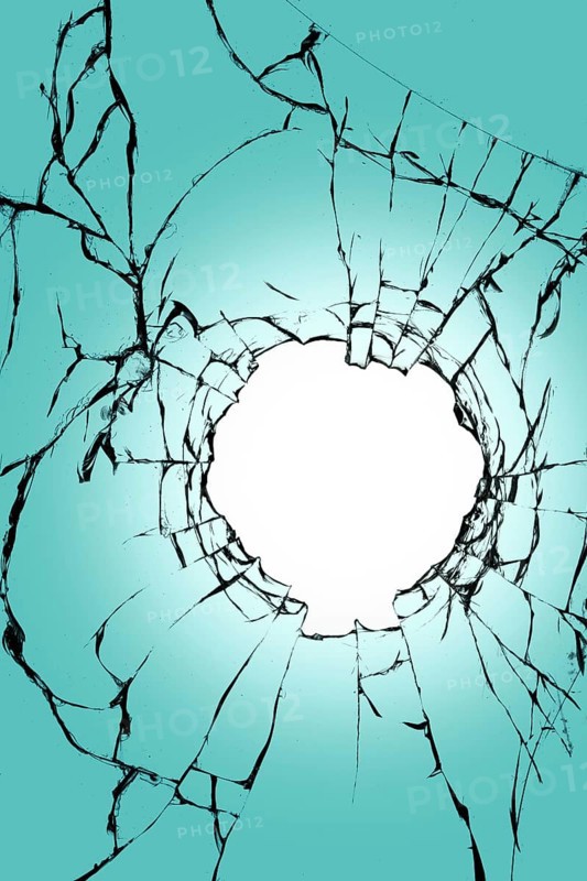 Stained glass with a hole in the middle on a blue background. Texture of black cracks and white background in the center