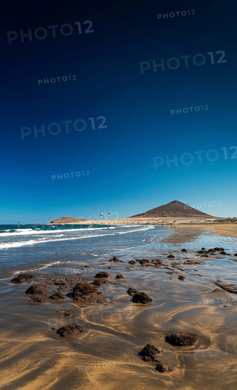 La tejita kite surfing beach and montana roja landmark in south tenerife spain