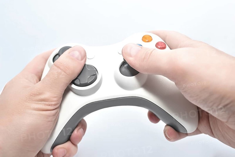 Joystick gamepad in the player's hands isolated on white background