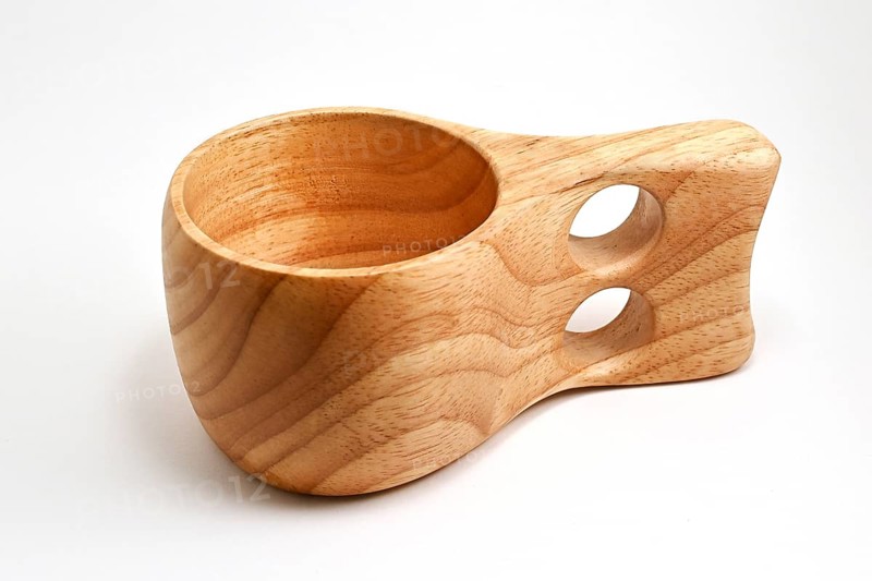 Traditional finnish wooden kuksa cup on white background, wood cup traditional used by the Saami people of Lapland