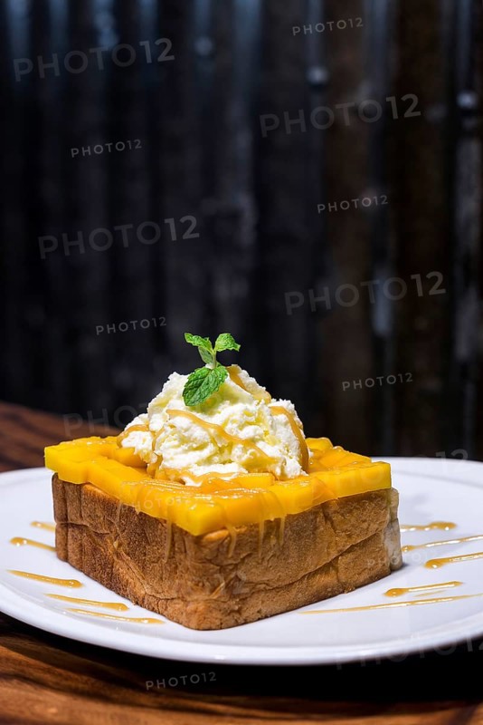 Gourmet fusion french toast with mango and whipped cream