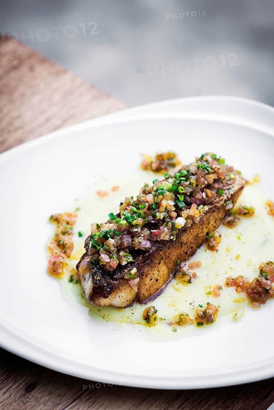 Sea bass fish with mexican tomato onion salsa sauce