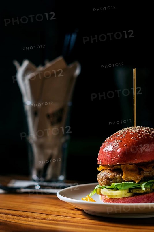 Modern gourmet trendy chicken burger in beetroot bun
