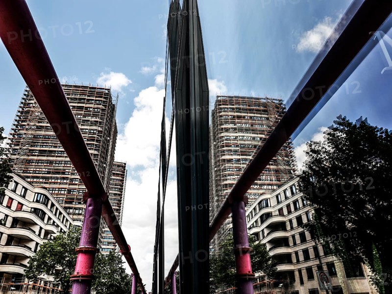 A new high-rise building is reflected in a glass façade, groundwater is pumped through pipes, new buildings at the East Side Gallery, Berlin, 02.07.2023