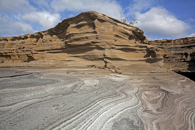 Pancake layered sandstone rock formations along the arid rocky coast on the island São Nicolau, Cape Verde, Cabo Verde, Western Africa, Africa