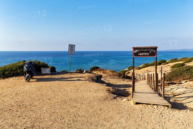 Motorbike on car park with beach access, boardwalk through dune landscape by the sea, Spiaggia di Scivu, Arbus, Costa Verde, Sud Sardegna, Sardinia, Italy, Europe