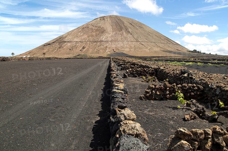 Volcano cone and black volcanic soil farmland, near Tinajo, Lanzarote, Canary Islands, Spain, Montana Tinache, Europe