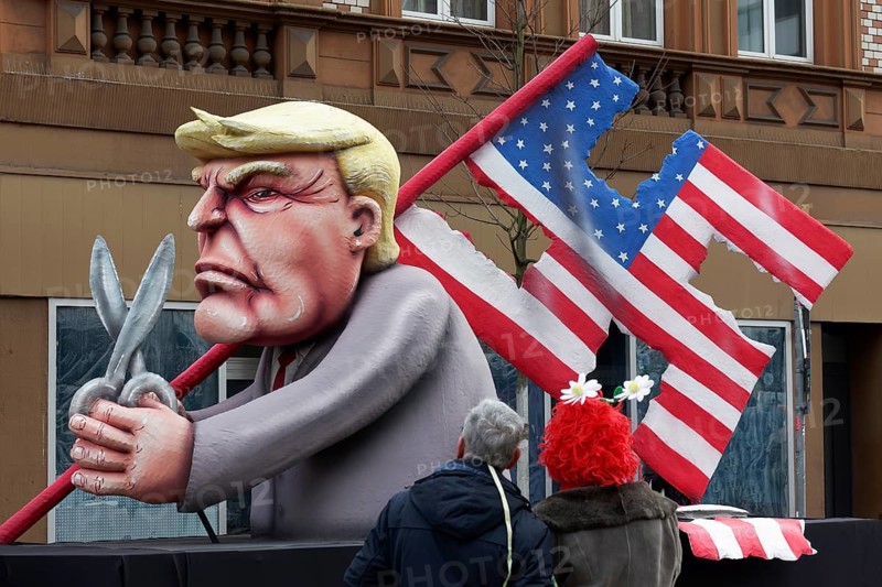 Donald Trump cuts a swastika flag out of the US national flag, danger to democracy, papier-mâché figure, satirical float by Jacques Tilly, Rose Monday parade Düsseldorf, North Rhine-Westphalia, Germany, Europe