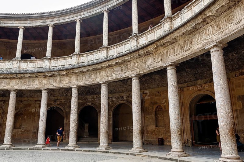 Palacio de Carlos V, Palace of Charles V, Renaissance palace in the Alhambra, gallery with columns made of conglomerate stone, tourists in the inner courtyard, Granada, Andalusia, Spain, Europe