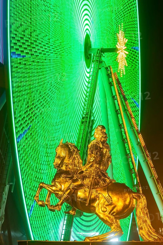 Augustus Market in Dresden. Equestrian statue of Augustus the Strong, also known as the Golden Horseman, with a Ferris wheel turning behind it, Dresden, Saxony, Germany, Europe